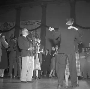 Dancing in the 1950s. The dance floor is filled with dancing couples moving to the music