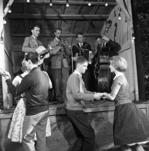 Dancing in the 1950s. A nice outdoor summer dance event where young couples are dancing and having fun