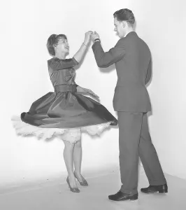 Dancing in the 1950s. A young couple is dancing in the 1950