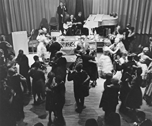 Dancing in the 1960s. A band is playing and the dance floor is filled with dancing couples that are enjoying themselves