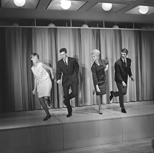 Dancing in the 1960s. The dance Hully Gully is being made popular and here are men and women dancing the new craze