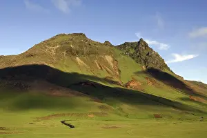 Dappled light on the Hatta hills near the village of Vik
