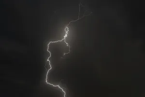 Dark clouds gather as lightning strikes light up the night