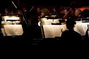 A dark image of an orchestra playing a symphony