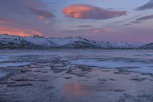 Dawn over an icy fjord, mountain landscape