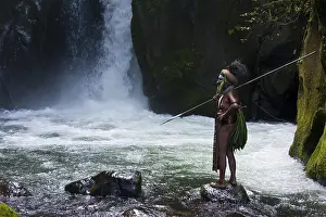 Faces Of The World Prints: Decorated and painted tribal chief standing in front of a waterfall in the Highlands
