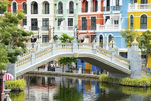 Decorative bridge with colorful buildings along a river