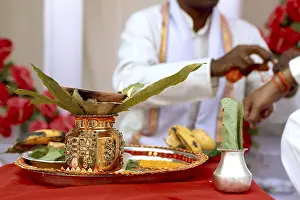 Decorative copper vessel with mango leaves offering to lord Wedding India