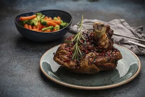 Delicious roasted ham or pork knuckle with glazed brown crispy skin