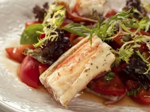 Delicious seafood crab salad on white plate on restaurant table background