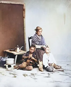 Delousing, mother examining her children's hair for lice