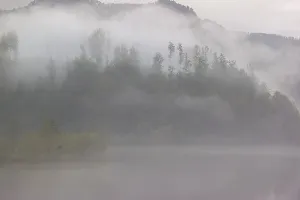 Dense fog on a lake on an early fall morning
