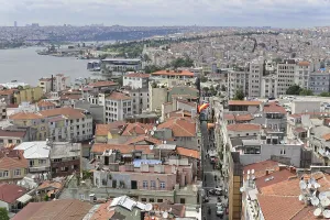 Dense urban development with red roofs and river in the background