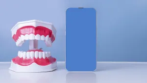 Dental model with smartphone display on blue background