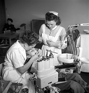 At the dentist in the 1940s. A boy is being examined and treated by a dentist