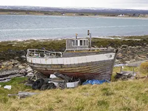 Derelict fishing boat on the shore of the Arctic Ocean