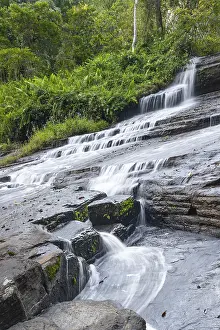 Derema Waterfall flows through thick vegetation