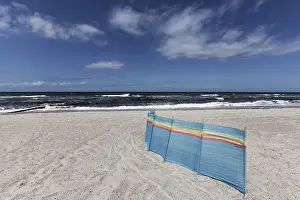 Deserted Baltic Sea beach with a single windbreak