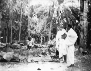 Destroyed buildings observed by three men after the riots between Hindus and Muslims in Noakhali East Bengal, November 1946, India, Asia