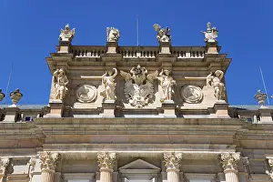 Detailed baroque facade art of a palace under a clear blue sky