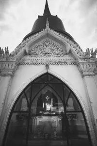 Detailed, majestic photograph of a stupa with ornate architectural details in black and white