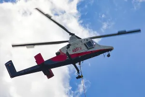 Detailed view of a helicopter with Rotex logo in the sky