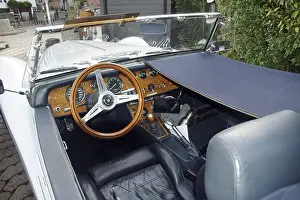 Detailed view of the interior of a classic convertible classic car with wooden steering wheel