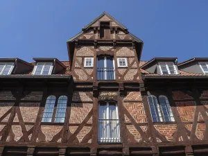 Detailed view of an old half-timbered house with historical charm under a blue sky