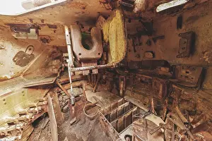 Dilapidated interior of a tank with rusty metal