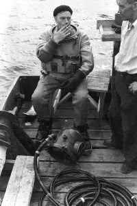 A diver in 1953, sitting in his diving suit and smoking a cigarette after a dive. One would have thought he would be happy only breathing the fresh air, once above the surface