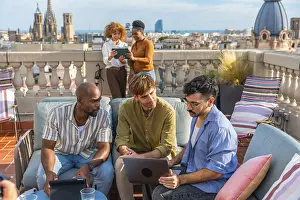 Framed Print : Diverse colleagues collaborate on a rooftop terrace in barcelona during a break