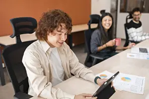 Diverse coworkers engage in teamwork at a modern office