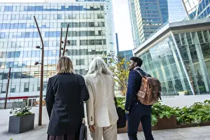 Diverse group of business people walking through a modern urban city district