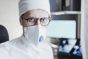 Doctor in a clinical setting wearing a mask