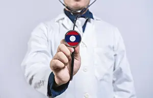 Doctor hands holding stethoscope with Laos flag