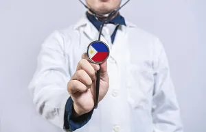 Doctor hands holding stethoscope with Philippines flag