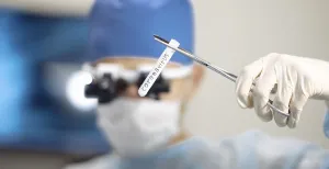 Doctor holding a test tube marked coronavirus
