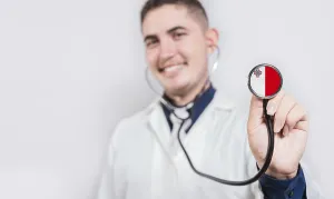 Doctor showing stethoscope with Malta flag