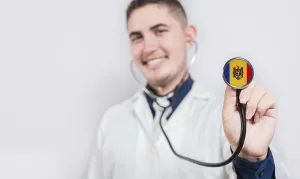 Doctor showing stethoscope with Moldova flag