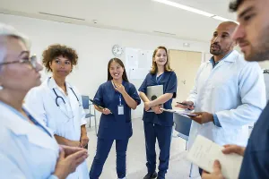 Doctors and nurses engaging in a collaborative discussion during a meeting at the hospital