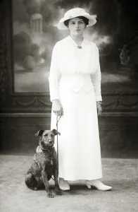 Dog next to woman in white dress
