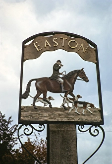Dorfschild mit der Darstellung eines Pferdes und eines Jaegers mit Hunden, fuer Easton, Suffolk, England, UK Juni 1975