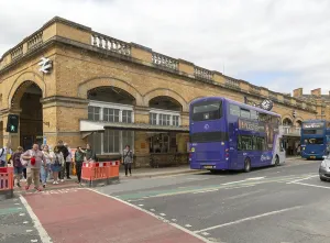 Double-decker buses outside York railway station building