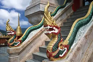 Dragon on staircase of tower with top of Chedi highest building in temple complex buddhist monastery Wat Chalong Wat