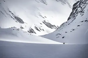 Dramatic atmosphere, Ski tourers in the vast landscape