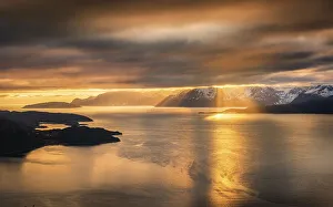 Dramatic cloud atmosphere with sunshine at the KvaenangenFjord