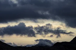 Dramatic clouds over Engadine mountains at blue hour