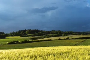 Dramatic cloudy sky with approaching storm and last rays of sunshine