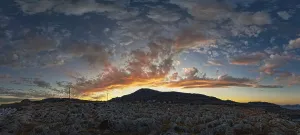 Framed Print : Dramatic landscape of Lindos with a mountain in the background and colourful sunset in the sky