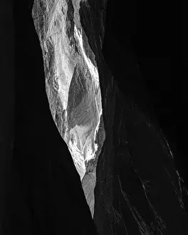 Dramatic narrow rock crevice with light shaft in Lauterbrunnen